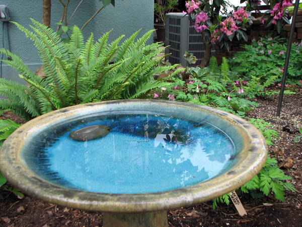 birdbath in a naturescaped yard
