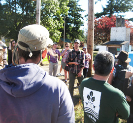 Rowan explains the irrigation system at Headwaters Farm to NIFTI Tour participants