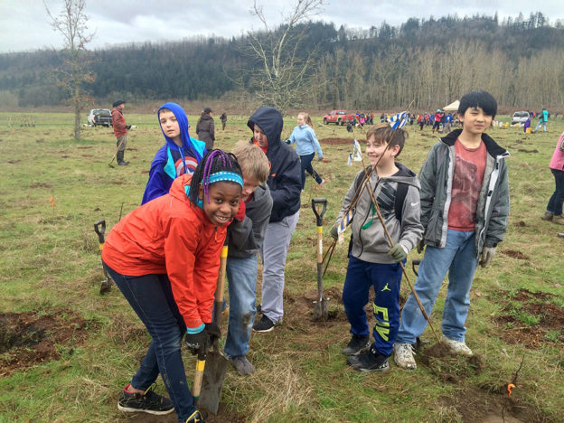 students planting at a grant project site